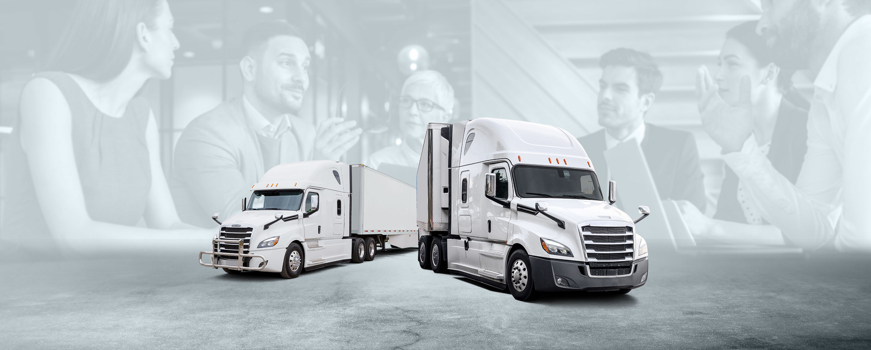 Two white Starship Freight transport trucks parked beside each other, with faded background of professionals in a meeting.